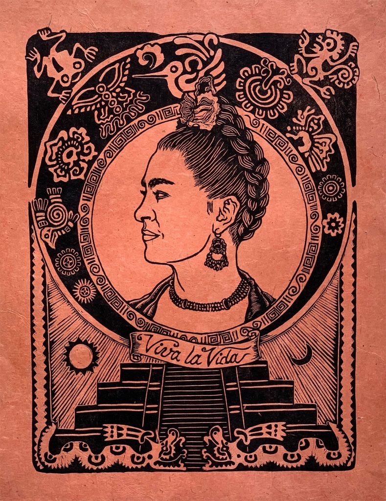 woodcut of profile of frida kahlo with mexican symbols border